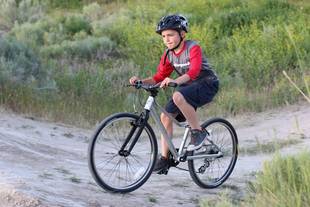 boy riding the Prevelo Alpha Four on a dirt trail