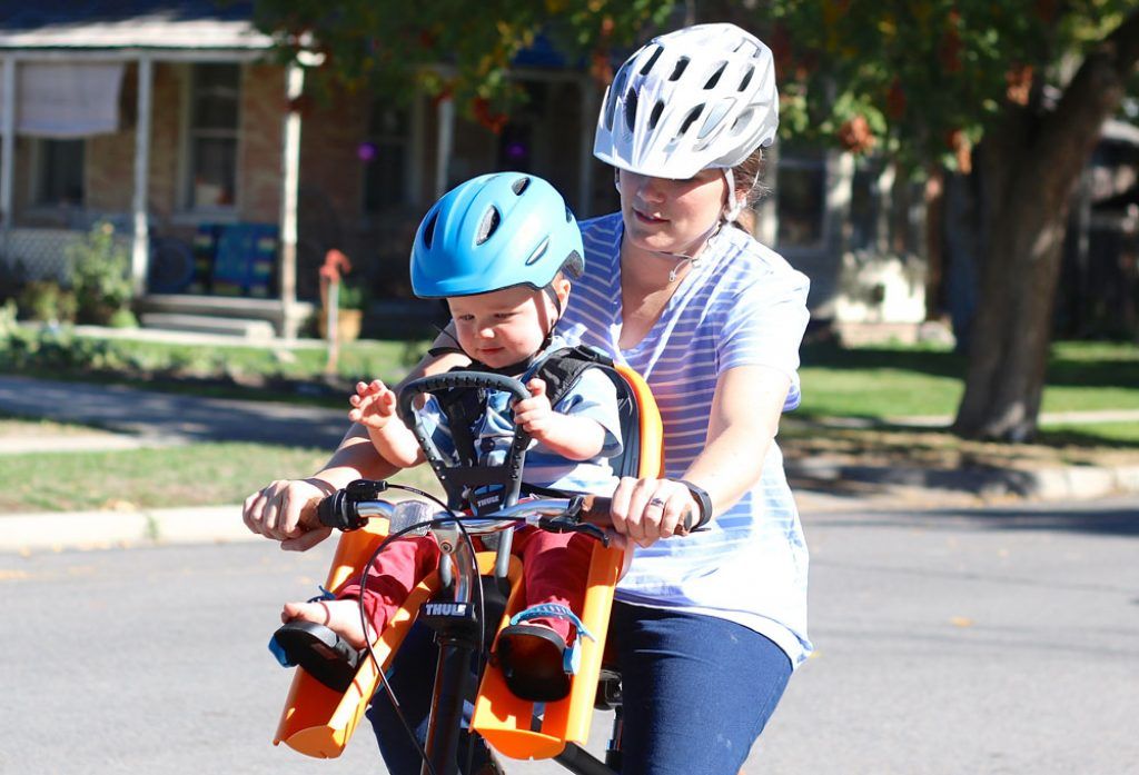 mom riding with her child in the thule ridealong mini child bike seat
