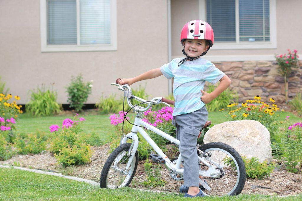 young boy riding the Priority Start 16 inch kids bike