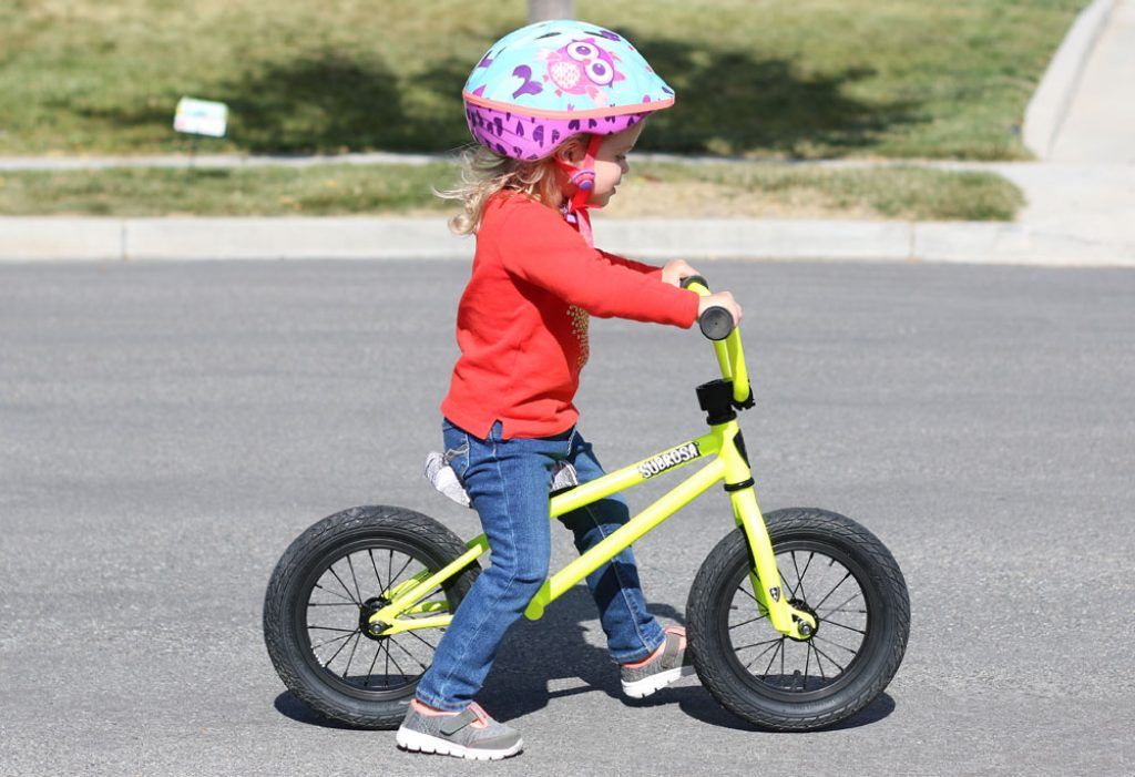 young girl riding the Subrosa altus balance bike