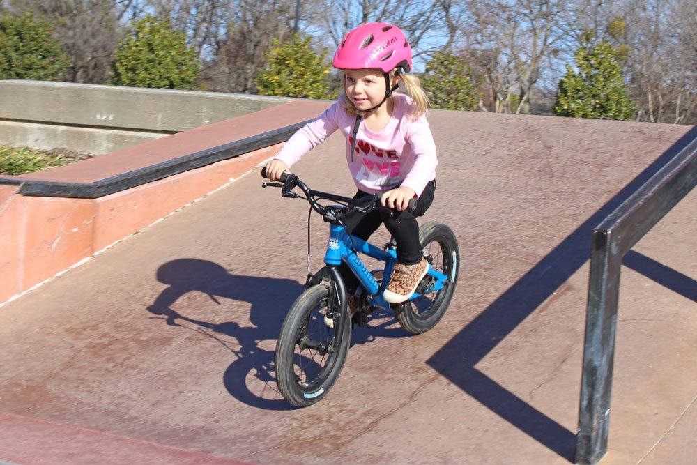 3 year old riding down a ramp at the skatepark on the Spawn Yoji 14 inch bike