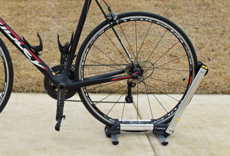road bike being held up by the topeak lineup stand up bike rack