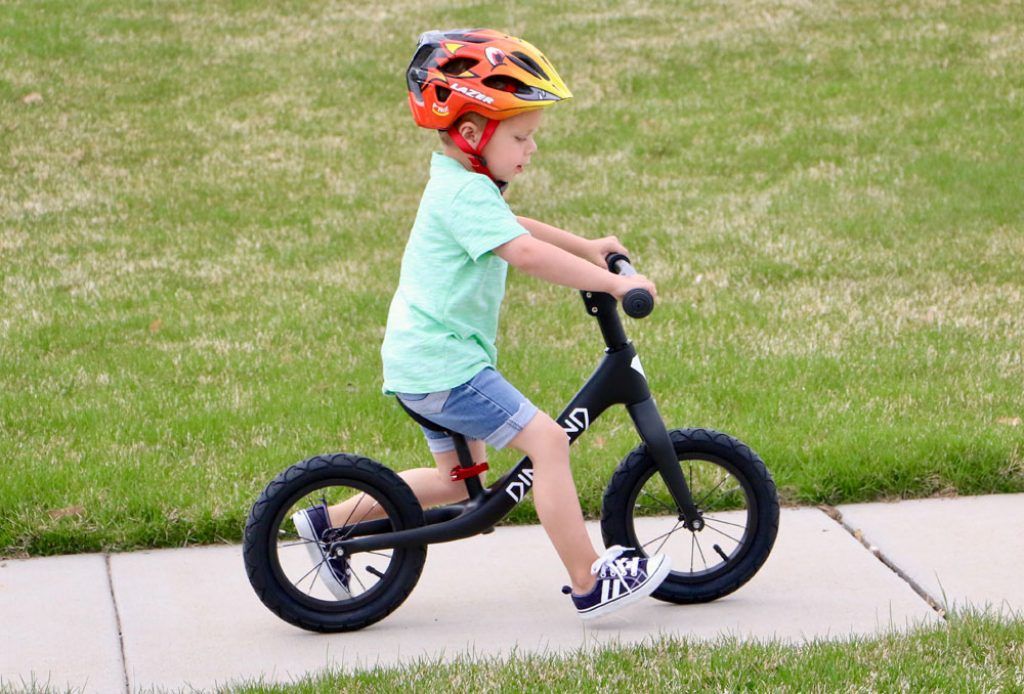 young boy riding the Dimond Miner balance bike