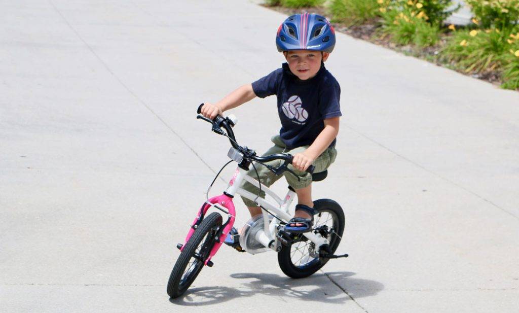 boy riding a royalbaby h2 14 inch bike