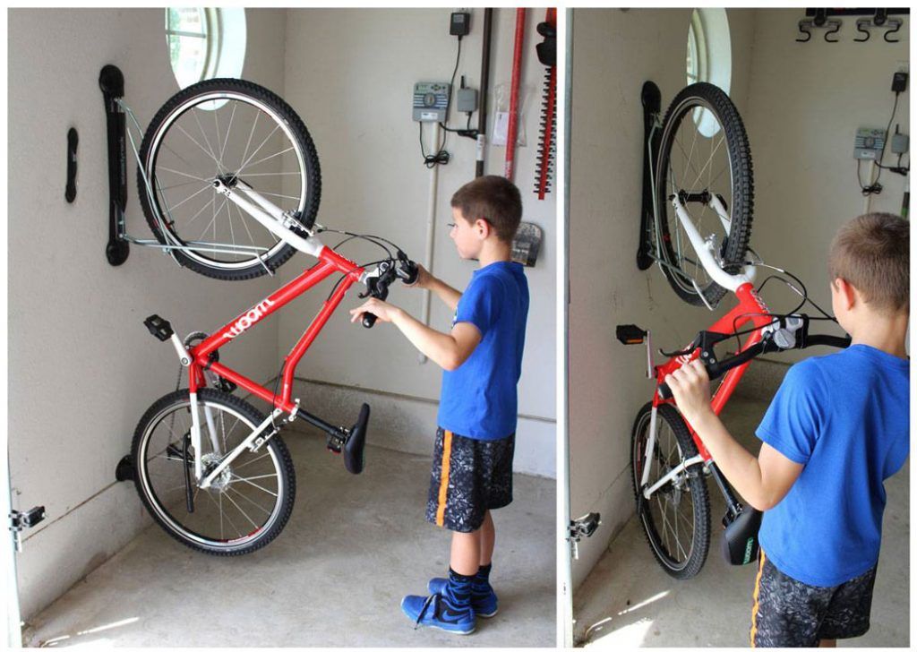 boy placing his woom 4 bike up on a steadyrack bike rack