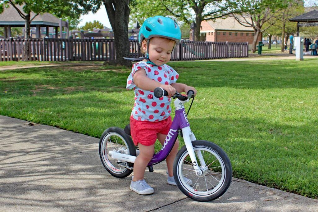 1 year old riding a woom balance bike for toddlers