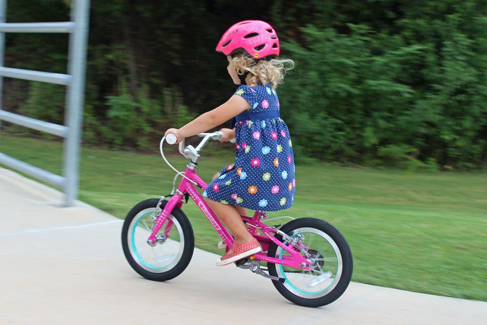 2 year old riding Guardian Ethos 14 kids bike down paved trail