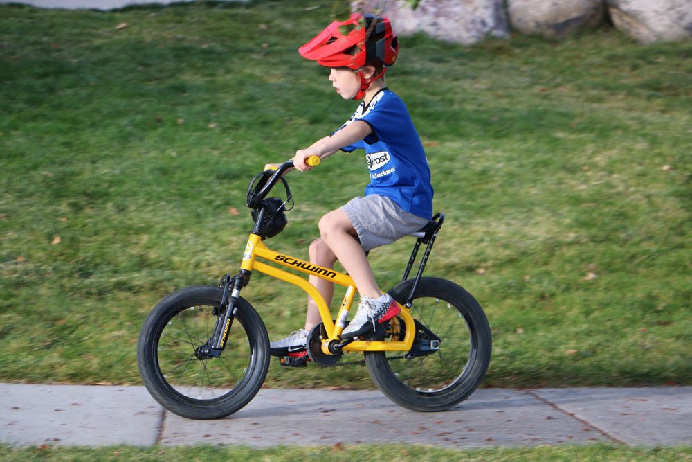 6 year old riding Schwinn Krate EVO kids bike down the sidewalk