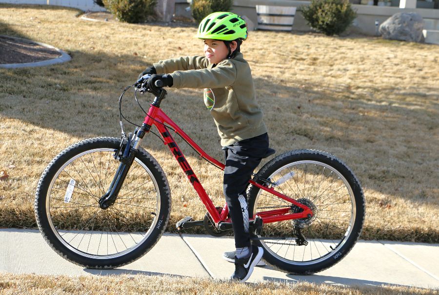 a boy trying test out the trek precaliber 24.  The bike is much to big for him.