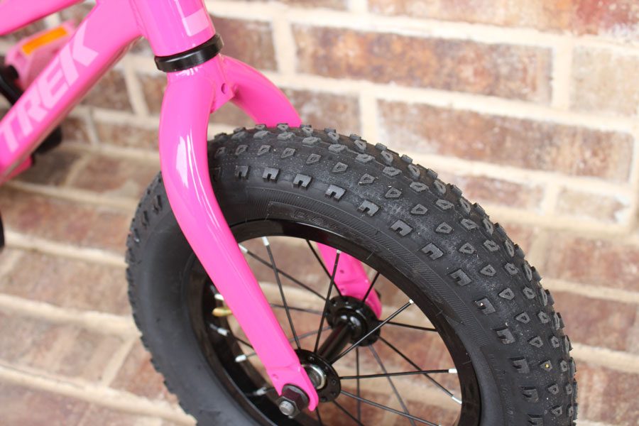 Wide, knobby 12 inch wheel and tire on Trek 12 inch bike