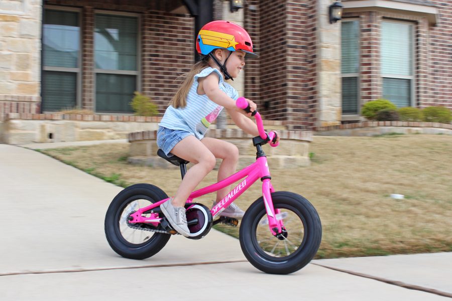 Toddler Specialized Riprock down the driveway previously known as the Specialized Hotrock