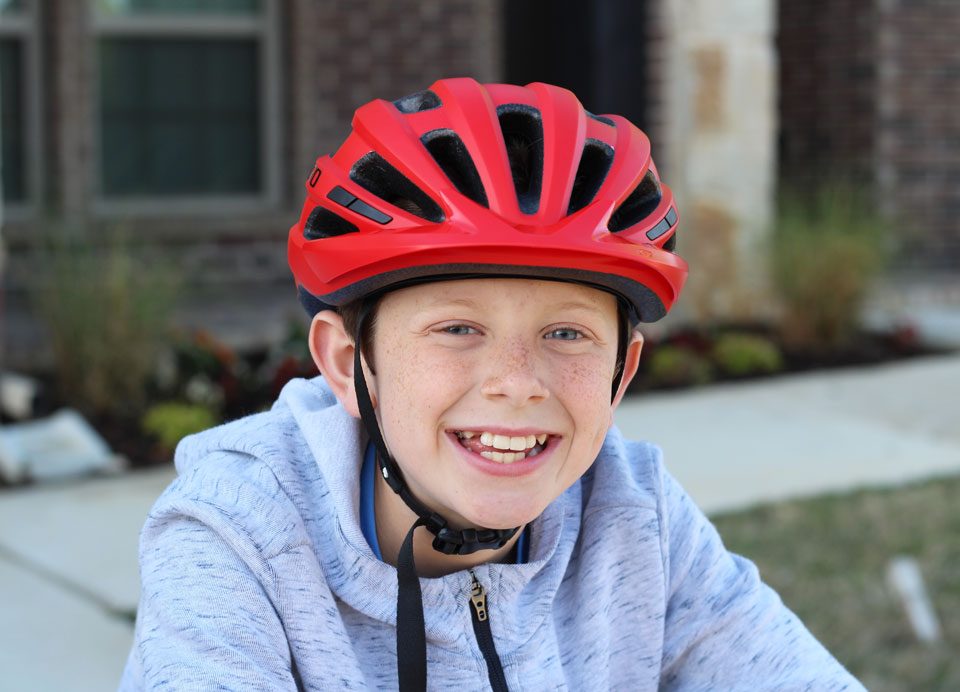 Boy wearing Giro Hale youth helmet in red