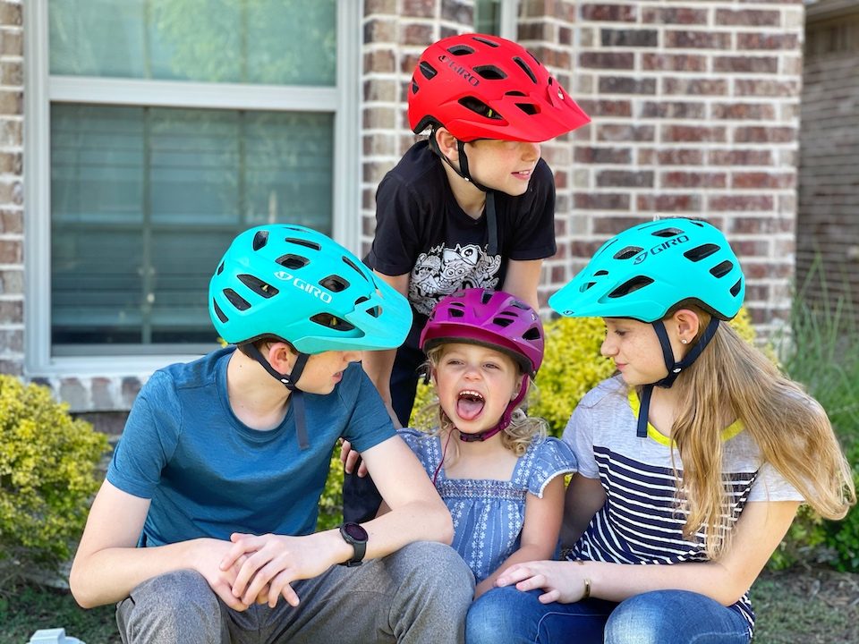 Group of four kids each wearing a Giro Tremor MIPS bike helmet