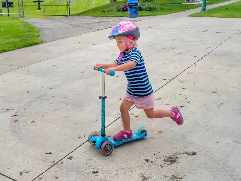 3 year old riding Micro Mini scooter at the park
