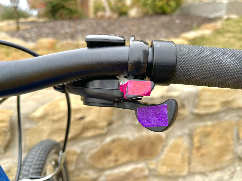 Trigger shifter buttons on Alpha Three color coded purple and pink.