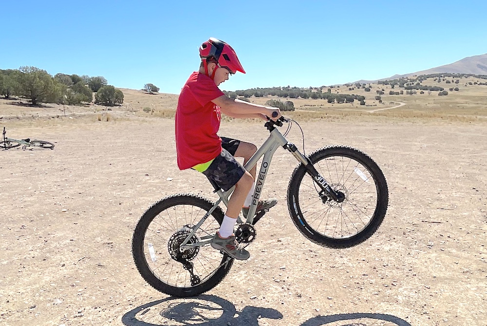 young rider doing a manual on the Prevelo Zulu Four mountain bike