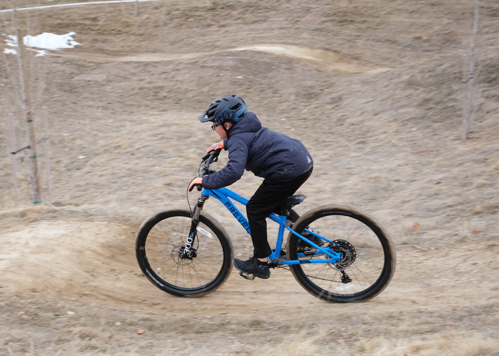 Young rider riding the Zulu at a bike park.