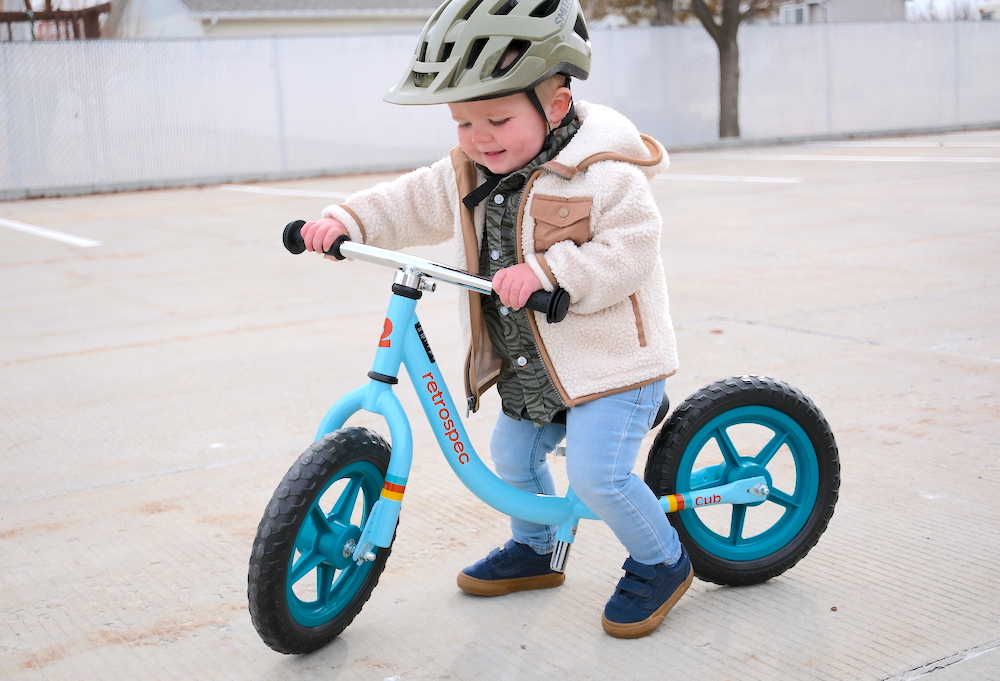 young toddler riding the Retrospec Cub balance bike