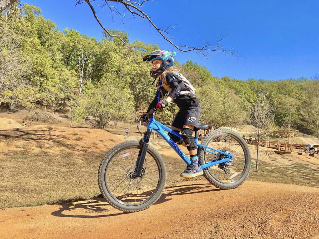 Young rider standing while riding the Prevelo Zulu Four mountain bike
