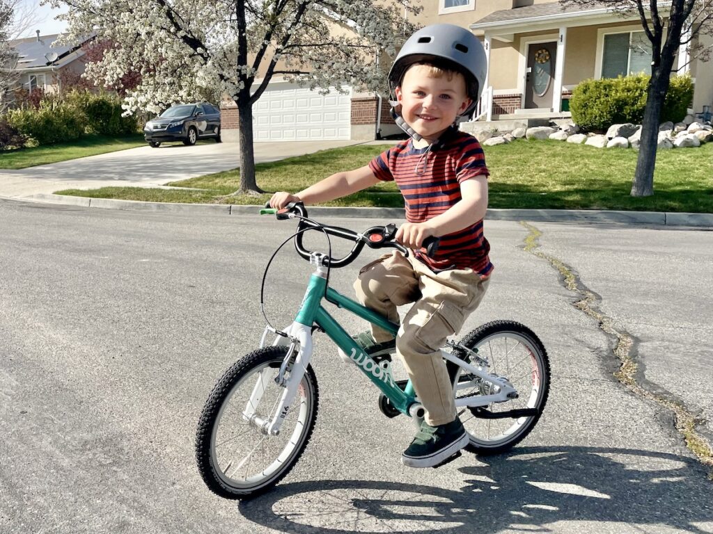 young boy riding the woom 3 16 inch bike