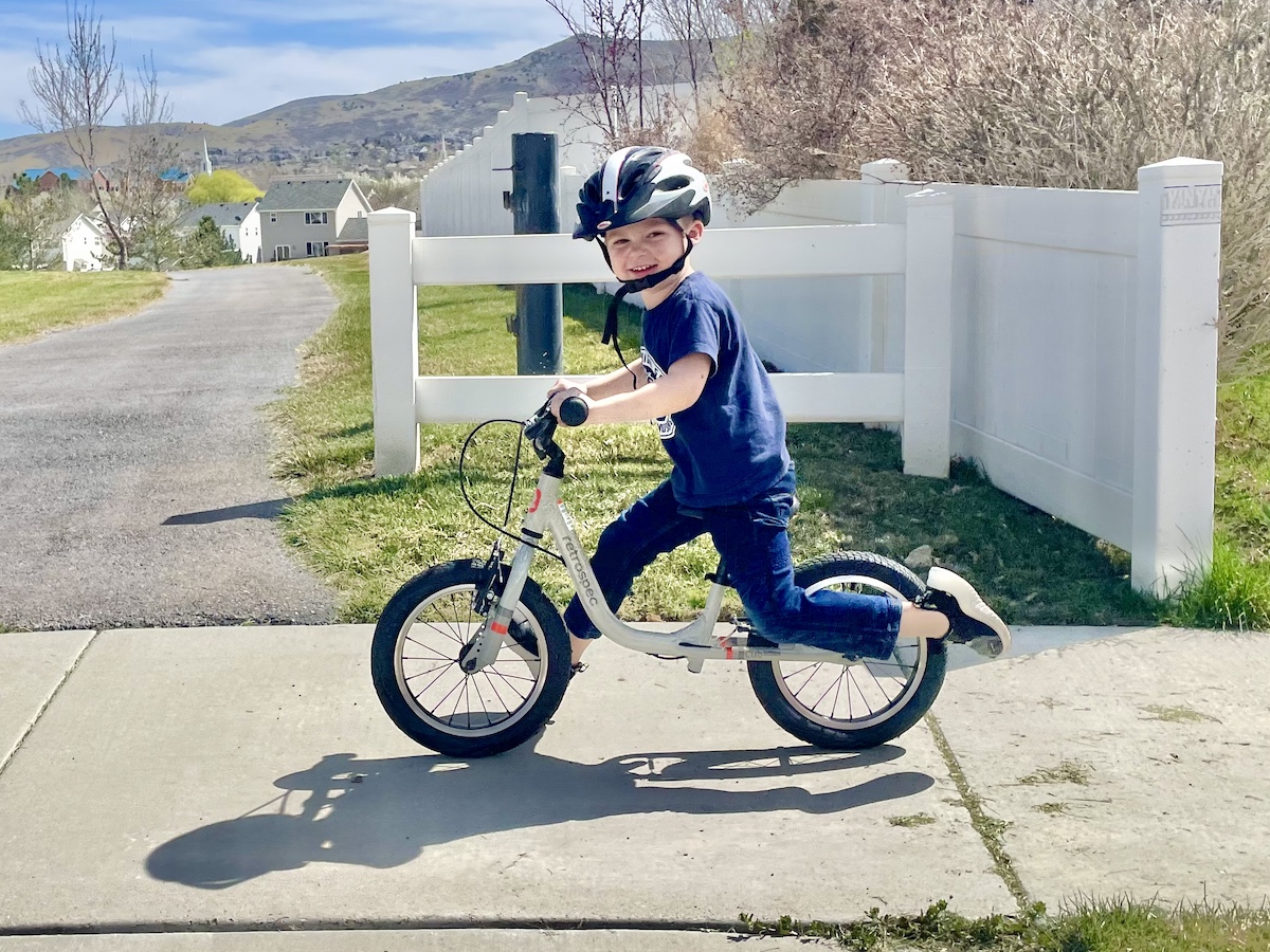 preschooler running on the retrospec cub plus XL balance bike