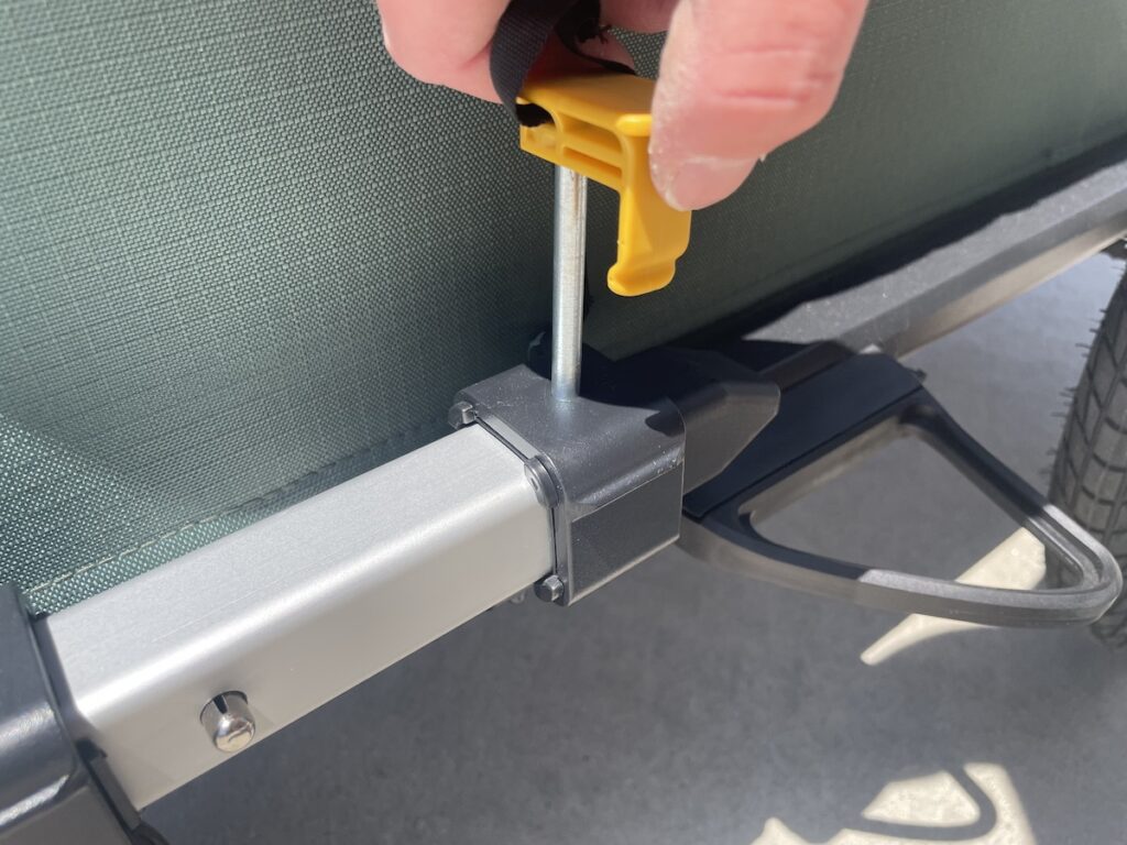 inserting the pin into the trailer arm of the Burley Hopper