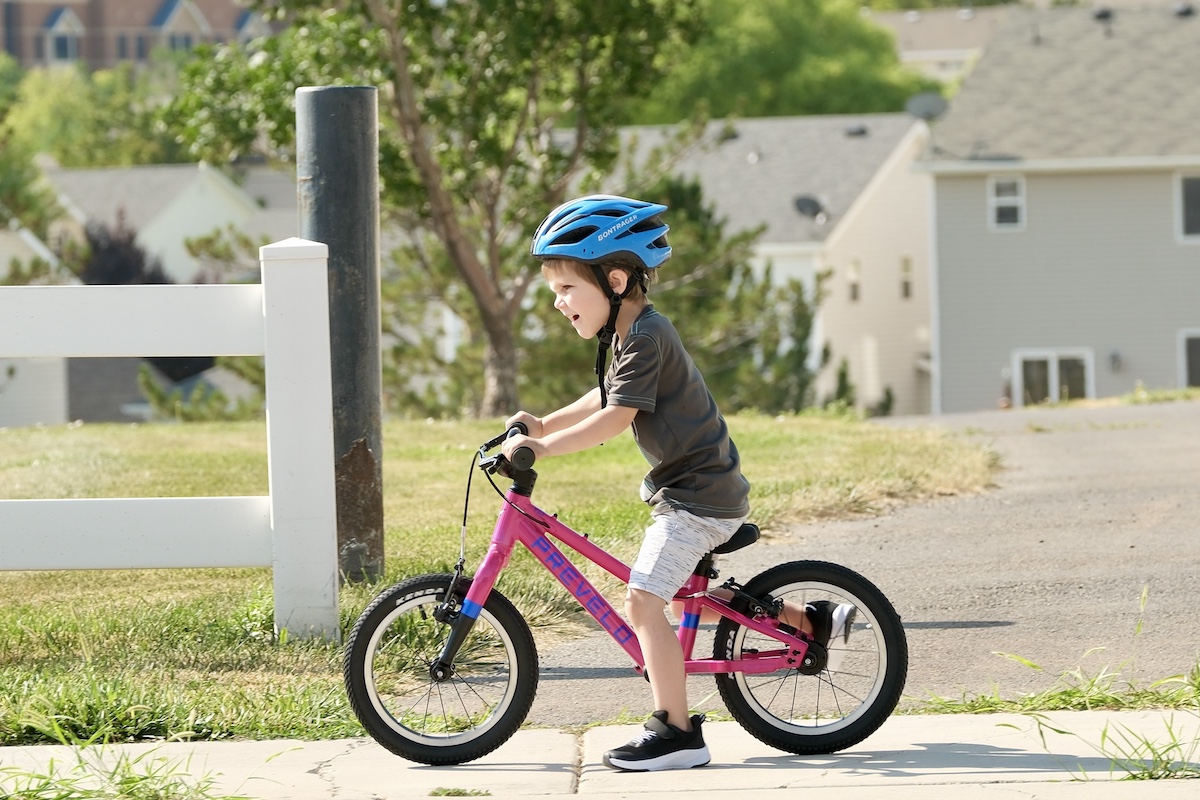 young kid riding the prevelo alpha one as a balance bike