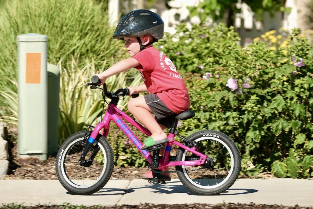 young boy riding the prevelo 14 inch pedal bike